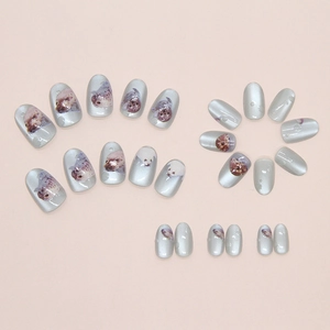 Detail of 24pcs silver cat-eye press-on nails featuring cute seal prints and glossy finish