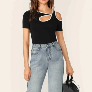 Close-up of black slim-fit top with white contrast piping and cutout neckline detail