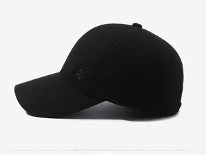 Detail view of the side profile on a black winter baseball cap with metal emblem accent