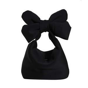 Minimalist black bow tote bag with large decorative handle on white background