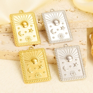 Détail de pendentifs en relief lune et soleil, finitions or et argent sur pierre
