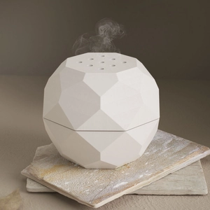 Close-up of geometric faceted incense burner silicone mold with a matte white finish