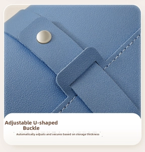 Detail of blue leather jewelry pouch with adjustable U-shaped buckle and metal snap