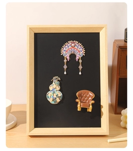 Detail view of magnetic frame showing traditional Phoenix crown and oriental floral charms