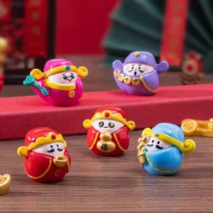 Close-up of five traditional Chinese resin figurines with 福 character on desktop