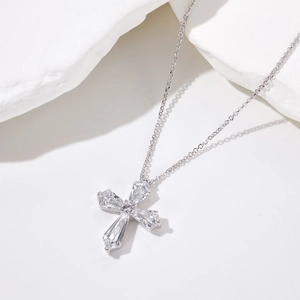 Detail of S925 silver cross pendant featuring baguette-cut stones and center pearl