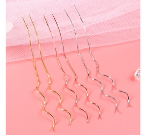 Detail view of long spiral threader earrings in gold, silver, and rose gold finishes