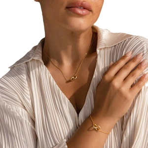 Gold and silver interlocking link necklace and bracelet set worn by a fashion model