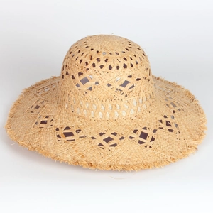 Handmade raffia straw sun hat with openwork patterns and frayed edges in natural beige