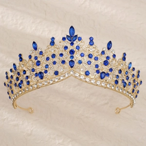 Detailed view of bridal crown with deep blue crystals and rhinestones on gold alloy base