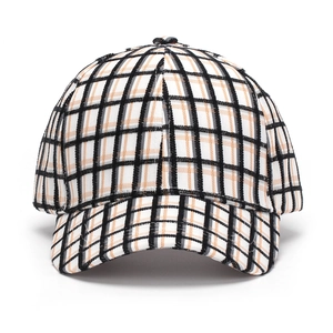 Close-up of the vintage plaid baseball cap fabric showing orange and black woven texture