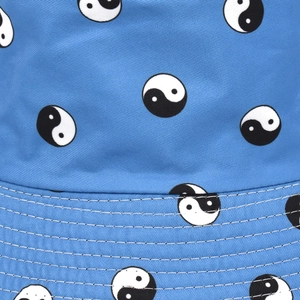 Blue bucket hat with yin yang prints featuring reinforced stitching and canvas texture