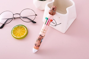 Close-up of 10-color Capybara ballpoint pen showing multi-color buttons and cute topper
