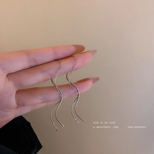 Silver wave tassel earrings with long spiral design in minimalist Korean style for women