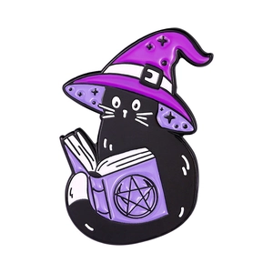 Detailed view of enamel cat wizard badge with black metal finish and purple witch hat