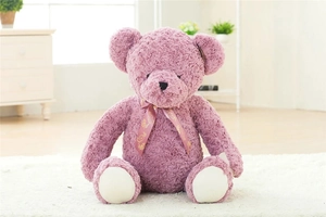 Detail of purple teddy bear plush shell featuring curly fur and a gold-patterned bow tie