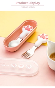 Close-up of cute cat paw stainless steel spoon and fork set in pink storage case