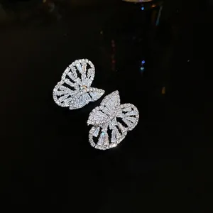 Elegant silver butterfly earrings featuring sparkling zircon inlay on a black background