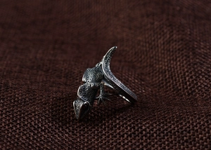 Macro detail of vintage silver lizard ring showing intricate scale textures and retro finish