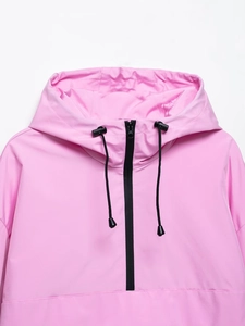 Close-up of pink hooded jacket with black drawstring toggles and half-zip detail