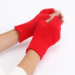 Close-up of red knitted fingerless gloves showing the detailed fish scale pattern texture