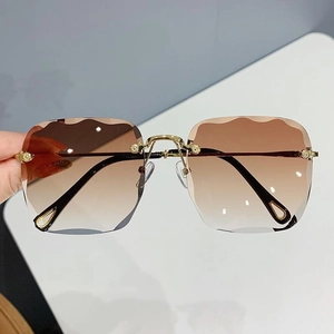 Trendy rimless square sunglasses with brown gradient lenses and wavy scalloped edges