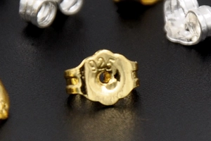Macro shot of 925 stamped butterfly earring back in 18K gold plated silver finish