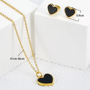 Elegant gold titanium steel jewelry set featuring black heart pendant and stud earrings