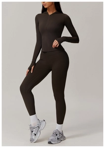 Detail of coffee brown yoga set featuring zip-up hoodie with thumbholes and leggings