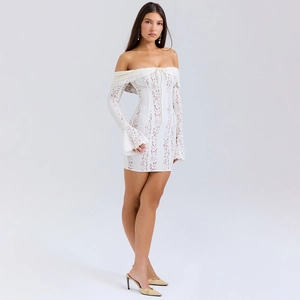 Detailed close-up of white lace mini dress featuring flare sleeves and neckline drawstring