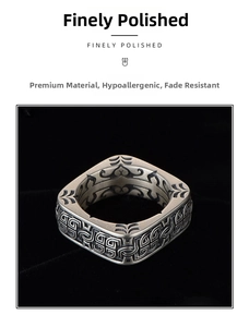 Macro detail of vintage square silver ring with intricate geometric engravings and matte finish