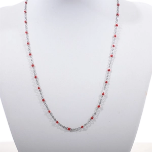 Detail of minimalist stainless steel chain necklace with red enamel beads on mannequin