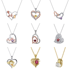 Detail of nine heart-shaped necklaces with Mom engravings and colorful gemstones