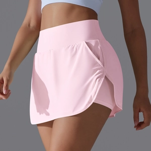 Detail view of pink high-waisted tennis skirt with back pocket and inner shorts