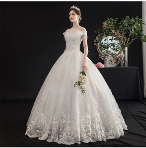 Detail of elegant off-shoulder wedding dress with lace embroidery and sequin embellishments