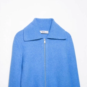 Women's light blue knit cardigan sweater with zipper and polo collar detail