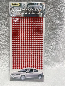 Detailed view of red 3mm self-adhesive acrylic rhinestone stickers in retail packaging