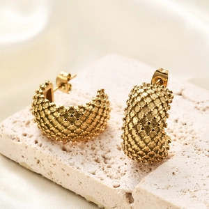 Macro view of gold 304 stainless steel C-shaped earrings with dotted grid texture