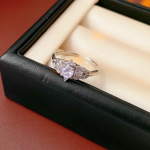Macro shot of silver ring featuring light purple zircon and sparkling crown detail