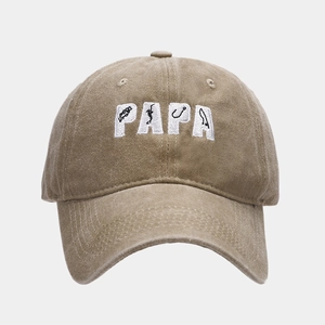 Close-up of PAPA embroidery with fishing motifs on washed cotton baseball cap
