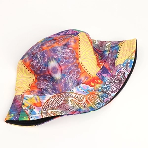 Detailed top view of the reversible bucket hat with colorful abstract graffiti print patterns