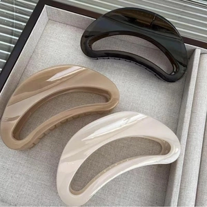 Three minimalist large hollow hair claws in gray, coffee, and beige for thick hair styling