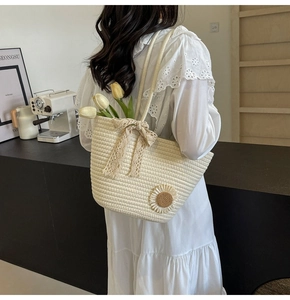 Detail of hand-woven cream tote bag with lace bow and daisy floral embroidery