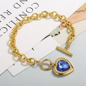 Detail of 18K gold stainless steel thick chain bracelet with blue heart crystal and OT toggle