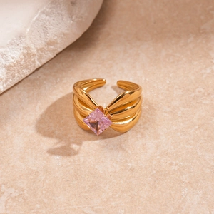 Macro shot of gold-plated multi-layer wavy ring featuring a pink square-cut zircon stone