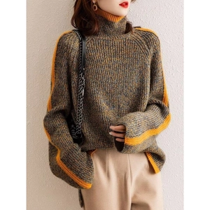 Detail of high neck knit sweater featuring grey marl fabric and orange contrast stripes