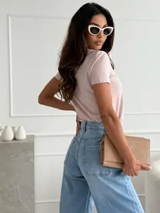 Rear view detail of slim fit light pink V-neck T-shirt paired with high waist jeans