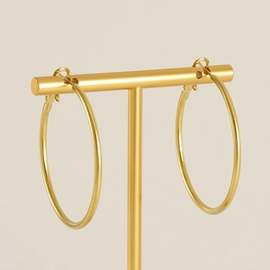 Classic large 18K gold plated hoop earrings displayed on a golden T-shape jewelry stand