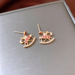 Detail of 18K gold-plated rocking horse stud earrings with red coin pattern and crystals