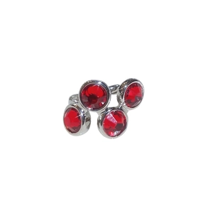 Silver hollow zircon ear cuff for women with sparkling red gemstones on white background